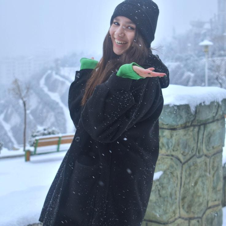 Ava Singh, Lead Design Curator at Isle Canvas Studio, reviewing corporate floral arrangements